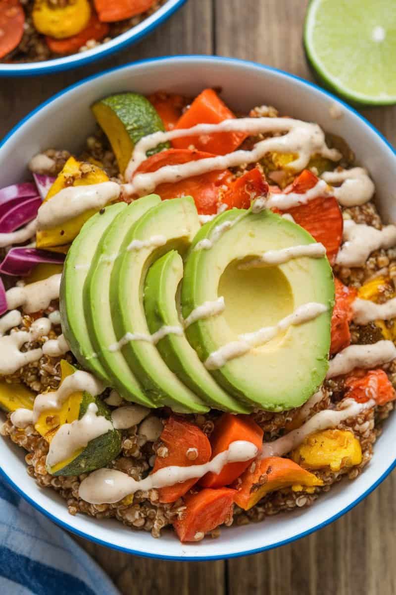 A colorful Spicy Chicken Quinoa Bowl with diced chicken, quinoa, fresh vegetables, and avocado slices.